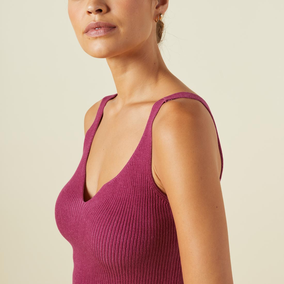 Close up view of model wearing the sweater rib tank in raspberry rose.