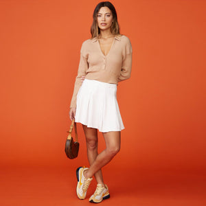 Front view of model wearing the sweater rib polo sweater in doe.