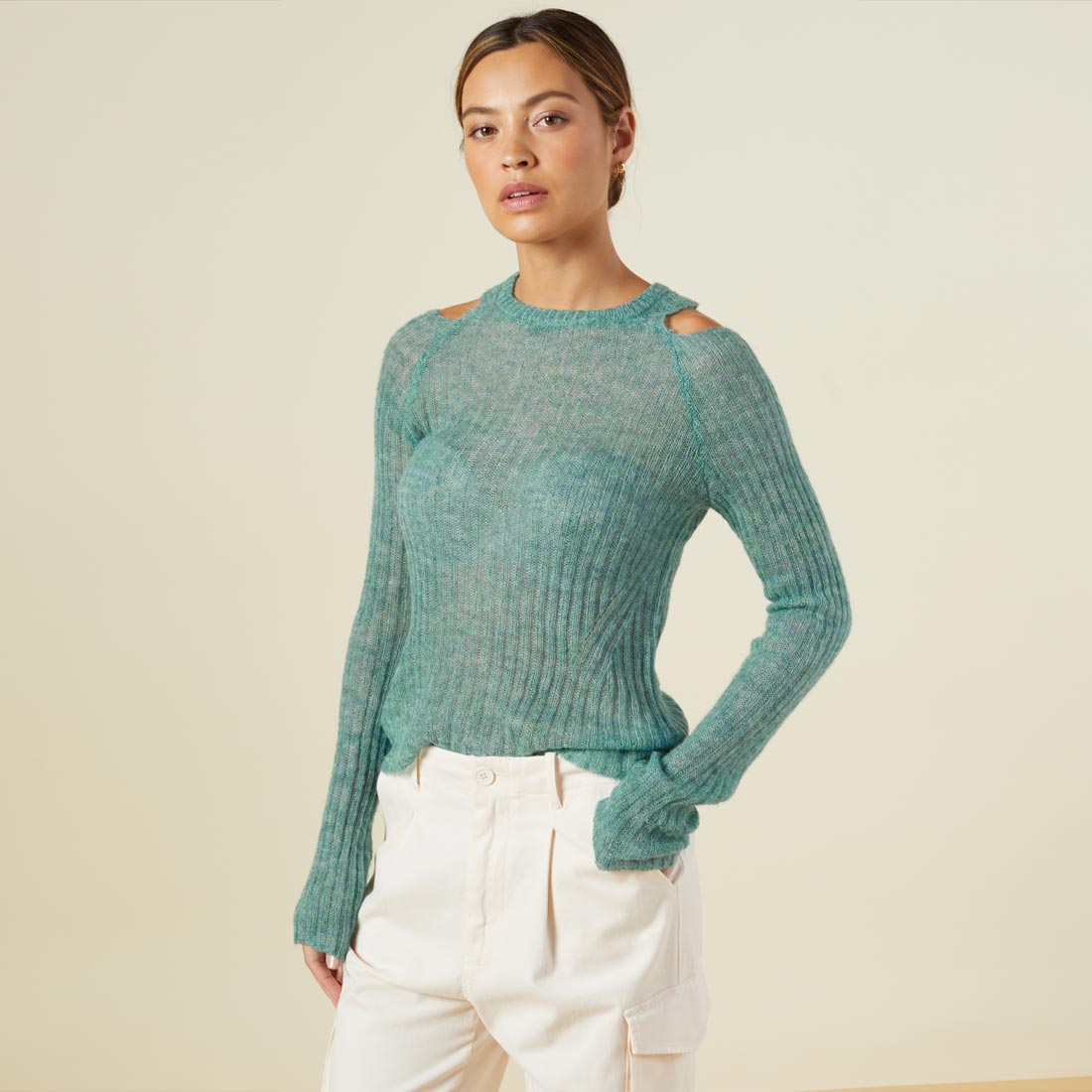 Side view of model wearing the mohair cut out sweater in kale green.
