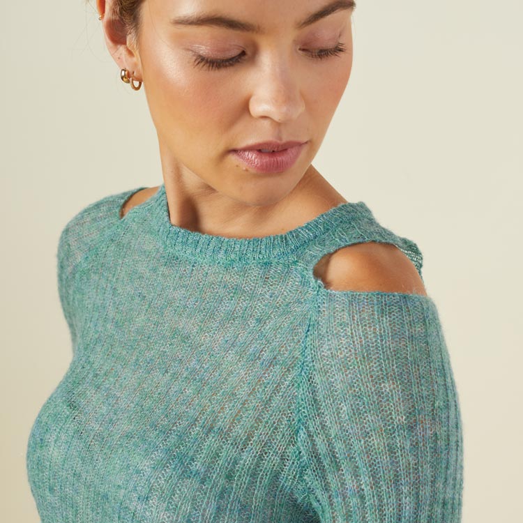 Close up view of model wearing the mohair cut out sweater in kale green.