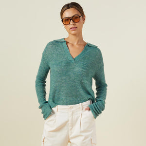 Front view of model wearing the mohair sweater in kale green.