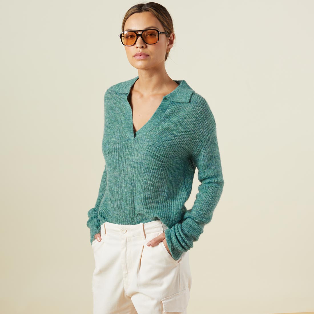 Side view of model wearing the mohair sweater in kale green.