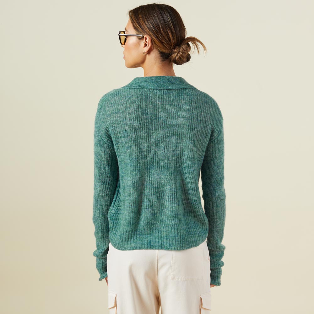 Back view of model wearing the mohair sweater in kale green.