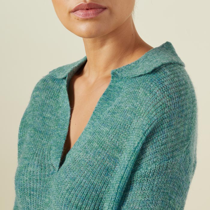 Close up view of model wearing the mohair sweater in kale green.