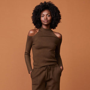 Front view of model wearing the supersoft sweater knit cold shoulder top in moss.