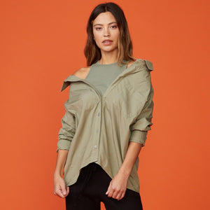 Front view of model wearing the poplin tank shirt in laurel green.