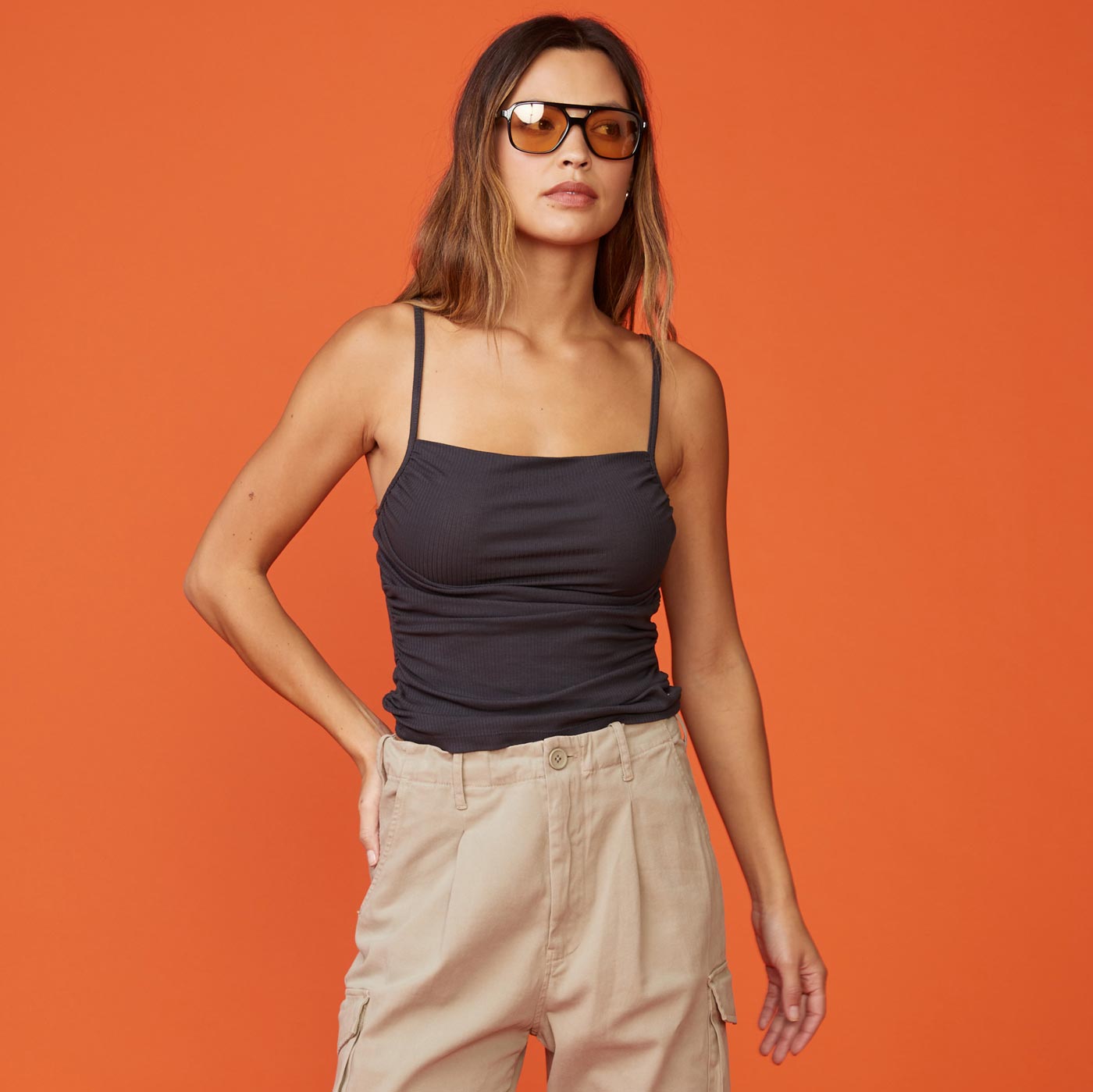 Front view of model wearing the rib shirred tank in faded black.