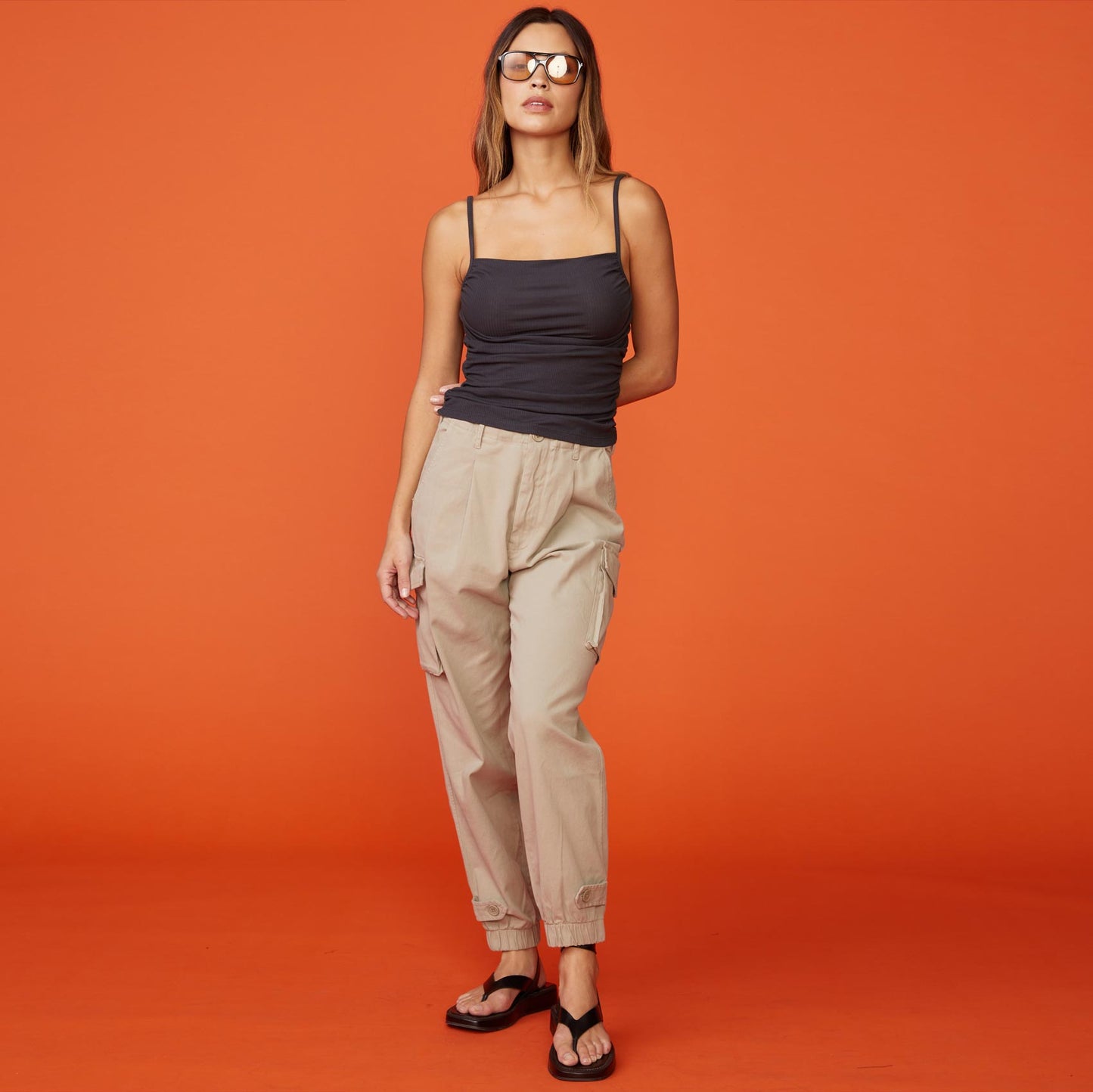 Front view of model wearing the rib shirred tank in faded black.
