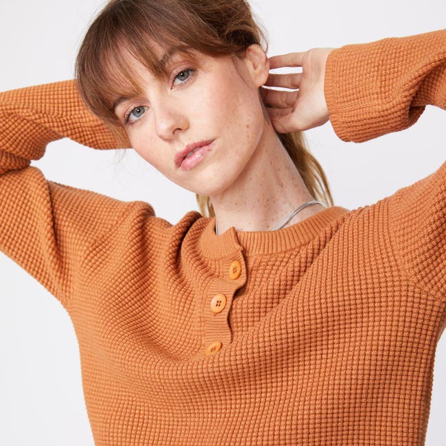 Close up view of model wearing the supersoft sweater knit henley top in nugget.