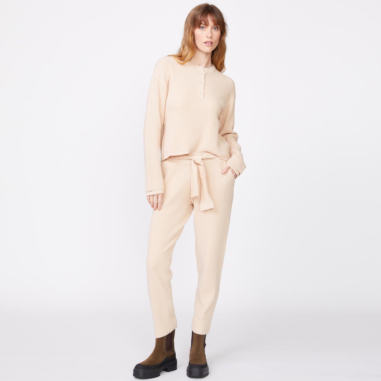 Front view of model wearing the supersoft sweater knit henley top in off white.