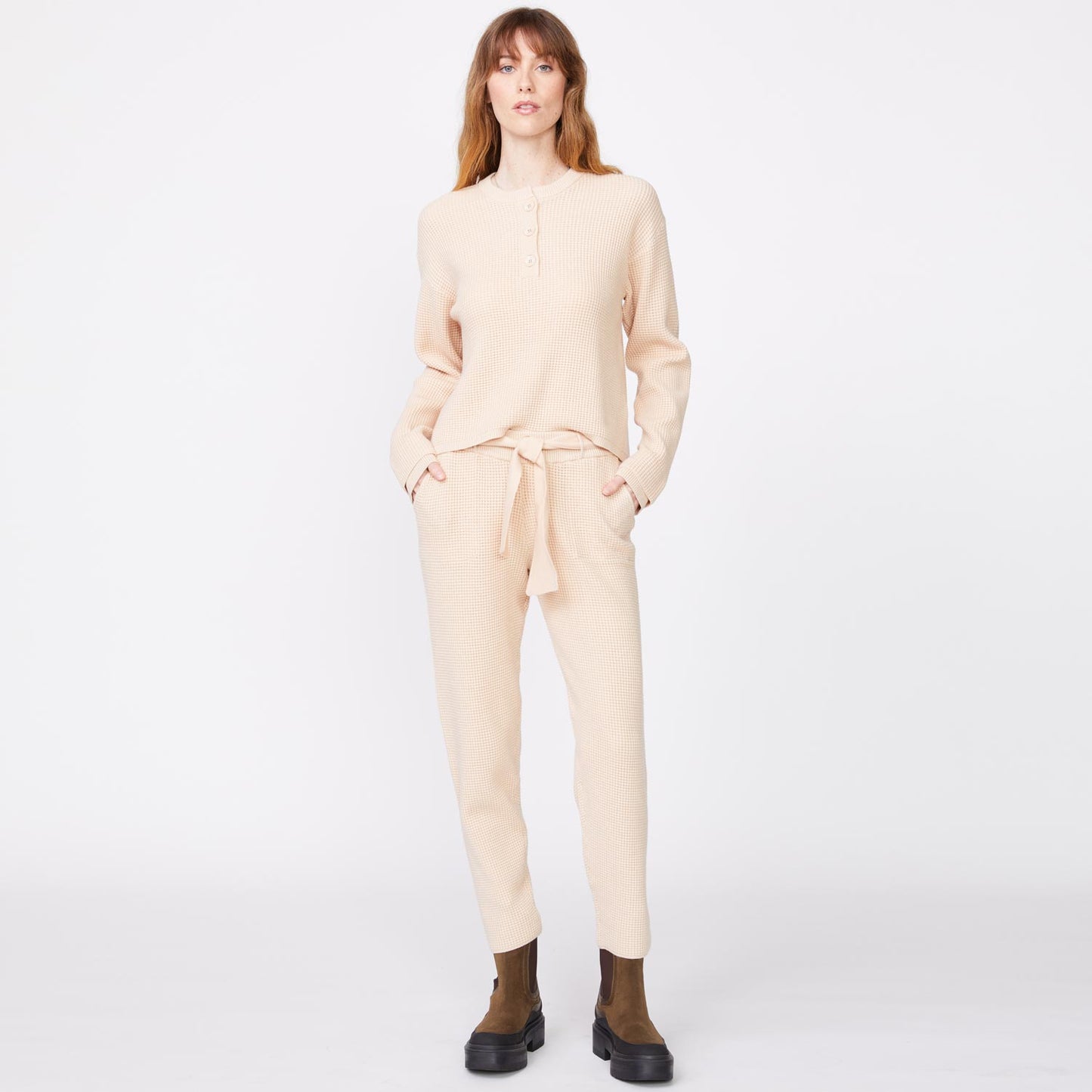 Front view of model wearing the supersoft sweater knit henley top in off white.