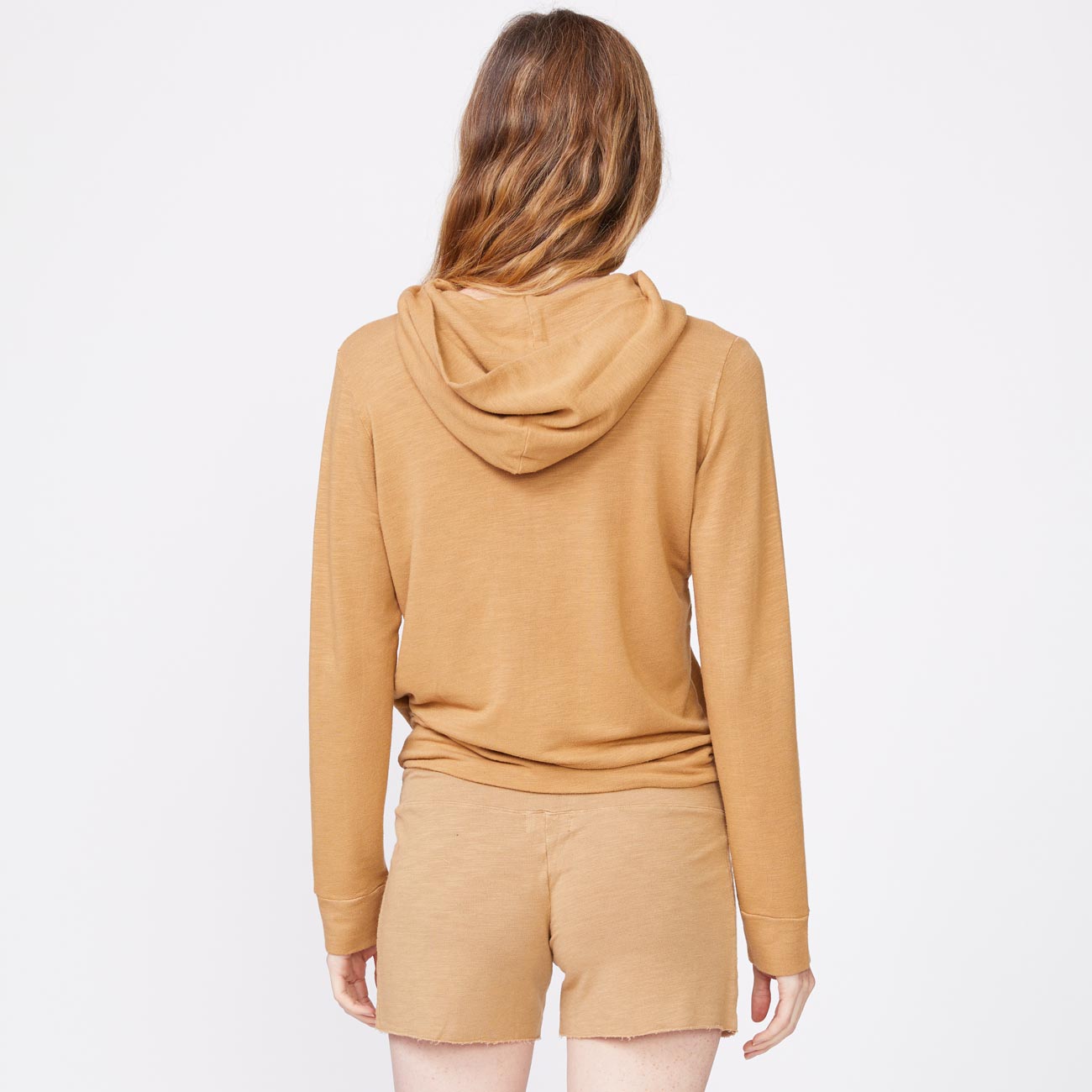 Back view of model wearing the supersoft pullover hoody in latte.