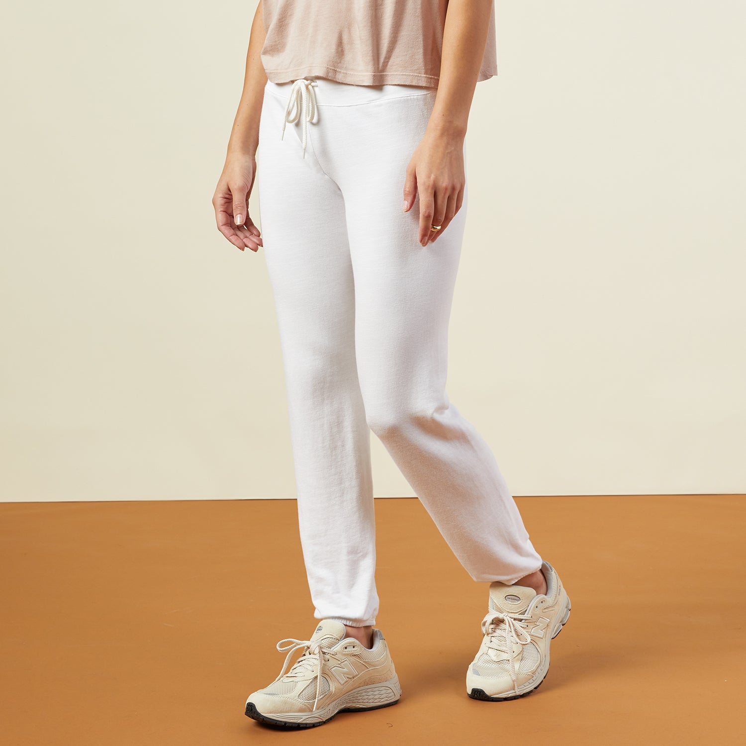 Side view of model wearing the supersoft vintage sweats in white.