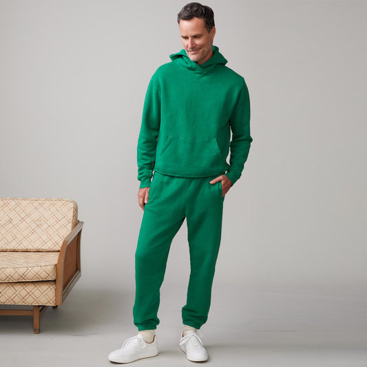 Front view of model wearing the oversized hoody in dusty kelly.