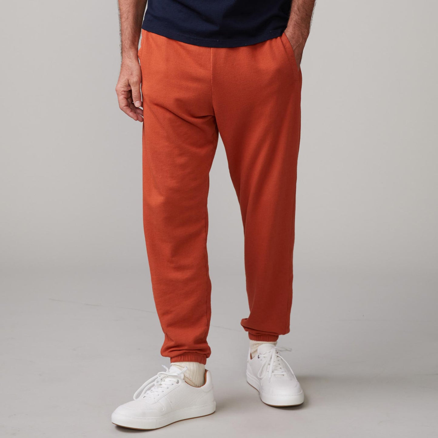 Front view of model wearing the lounge sweats in faded rust.