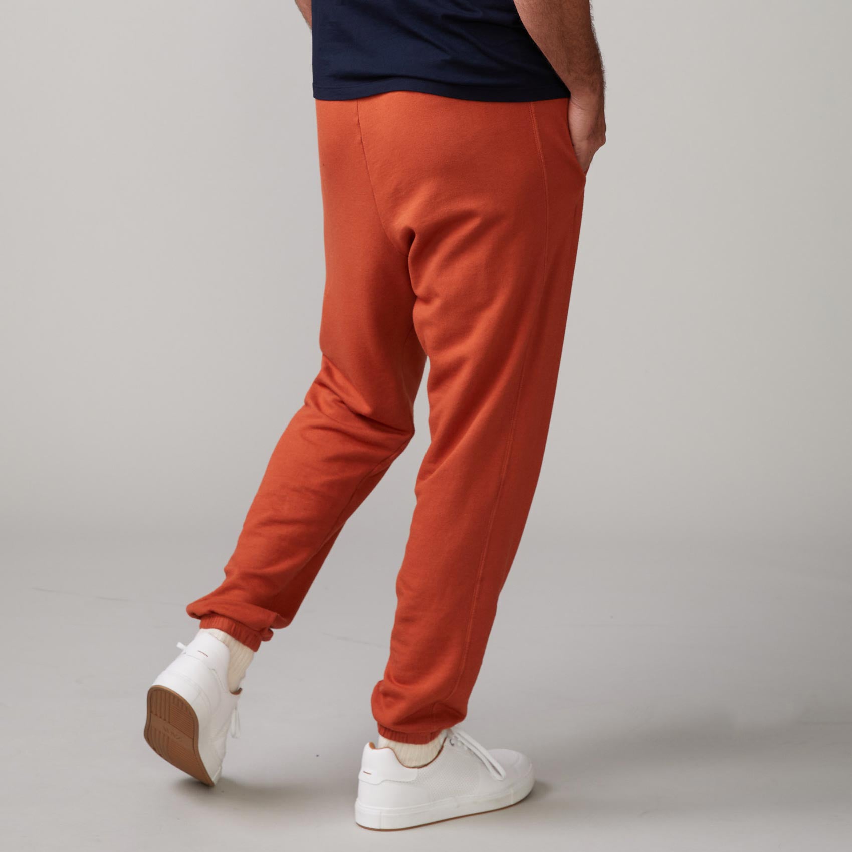 Back view of model wearing the lounge sweats in faded rust.