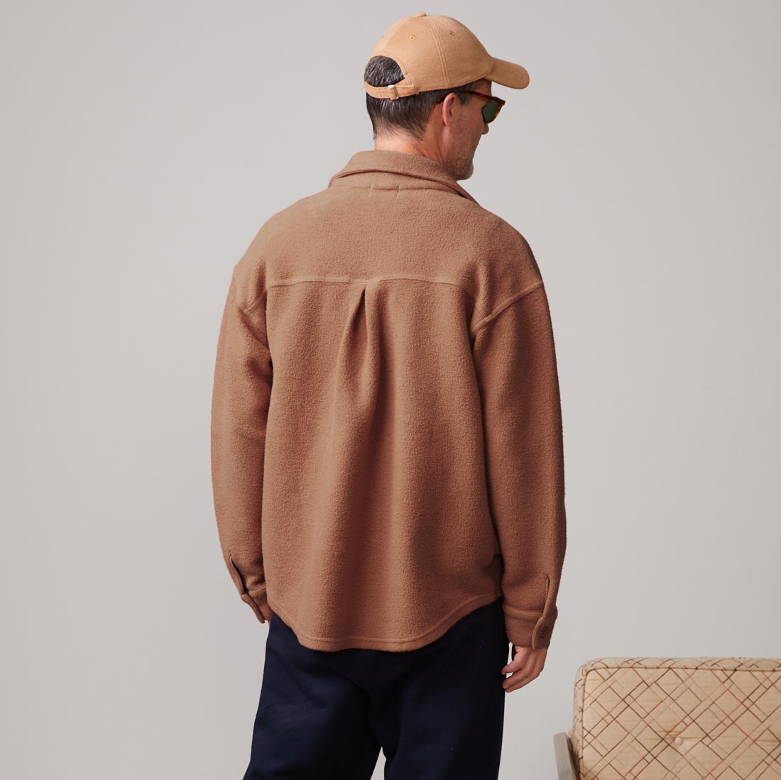 Back view of model wearing the teddy fleece shacket in Rust.