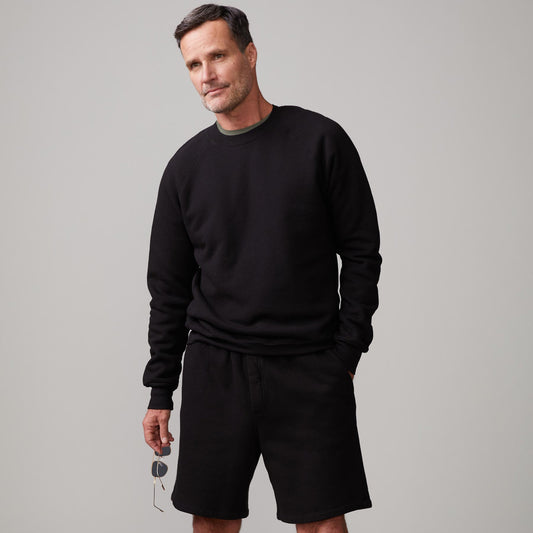 Front view of model wearing the 70's raglan in black.