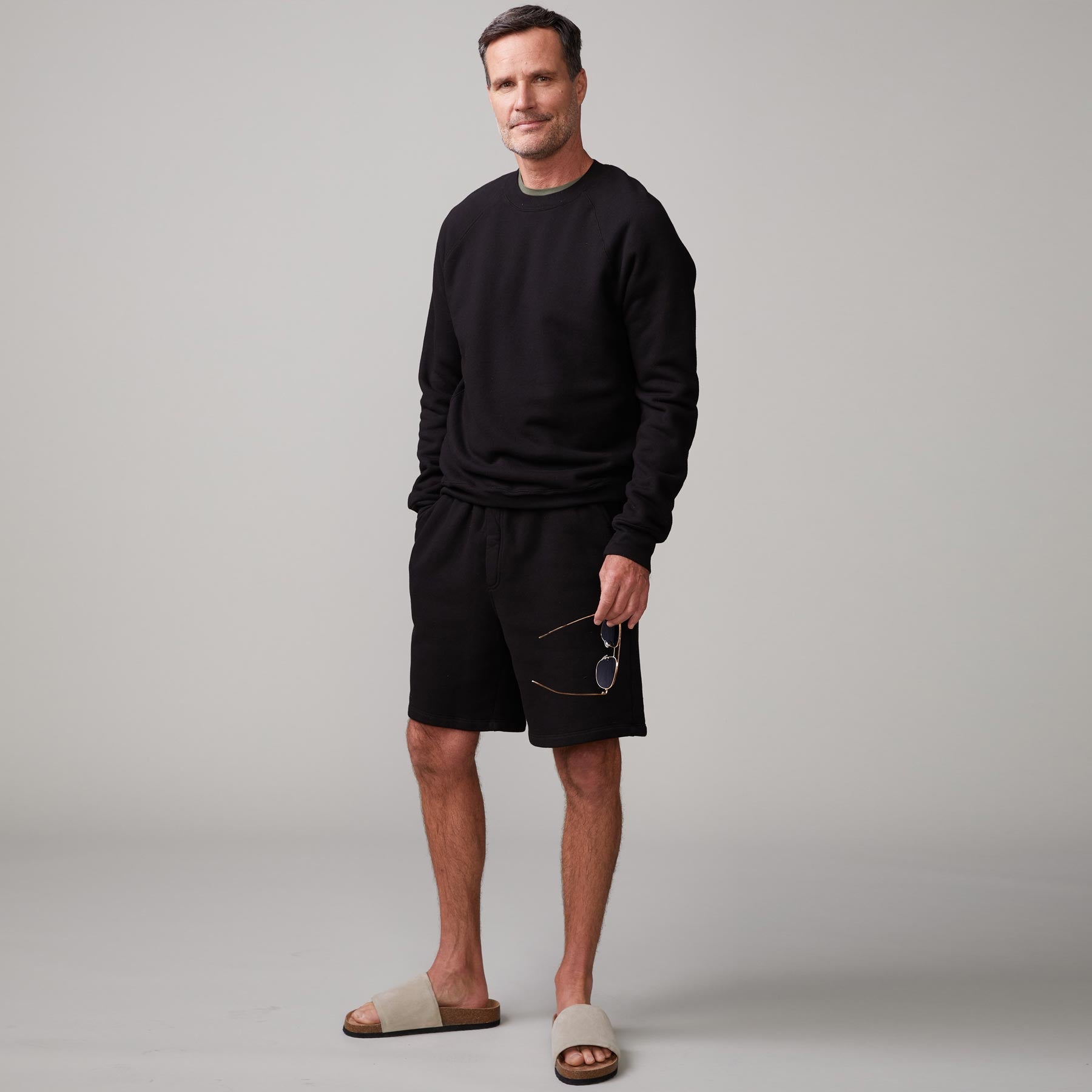 Front view of model wearing the 70's raglan in black.