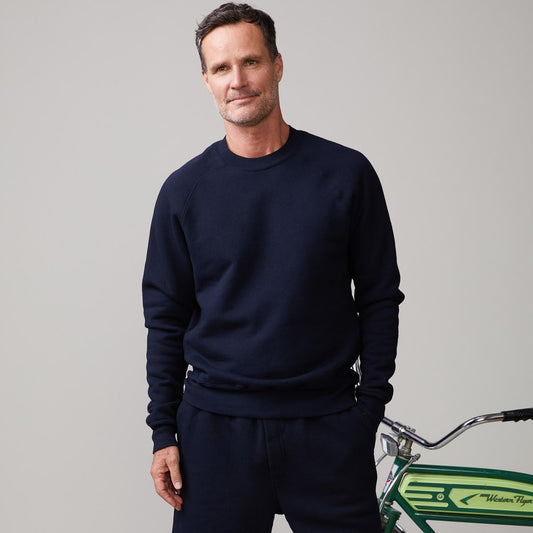 Front view of model wearing the 70's raglan in indigo.