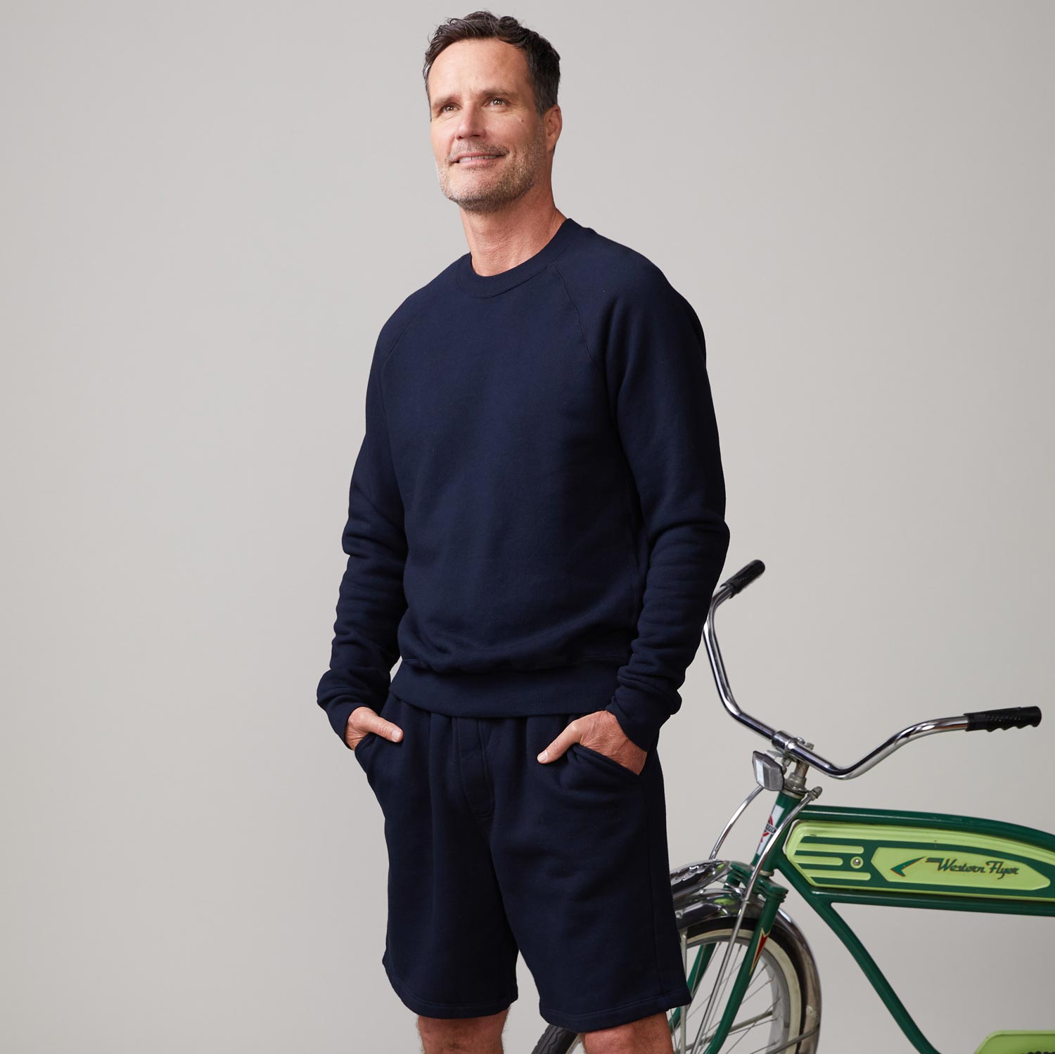 Side view of model wearing the 70's raglan in indigo.