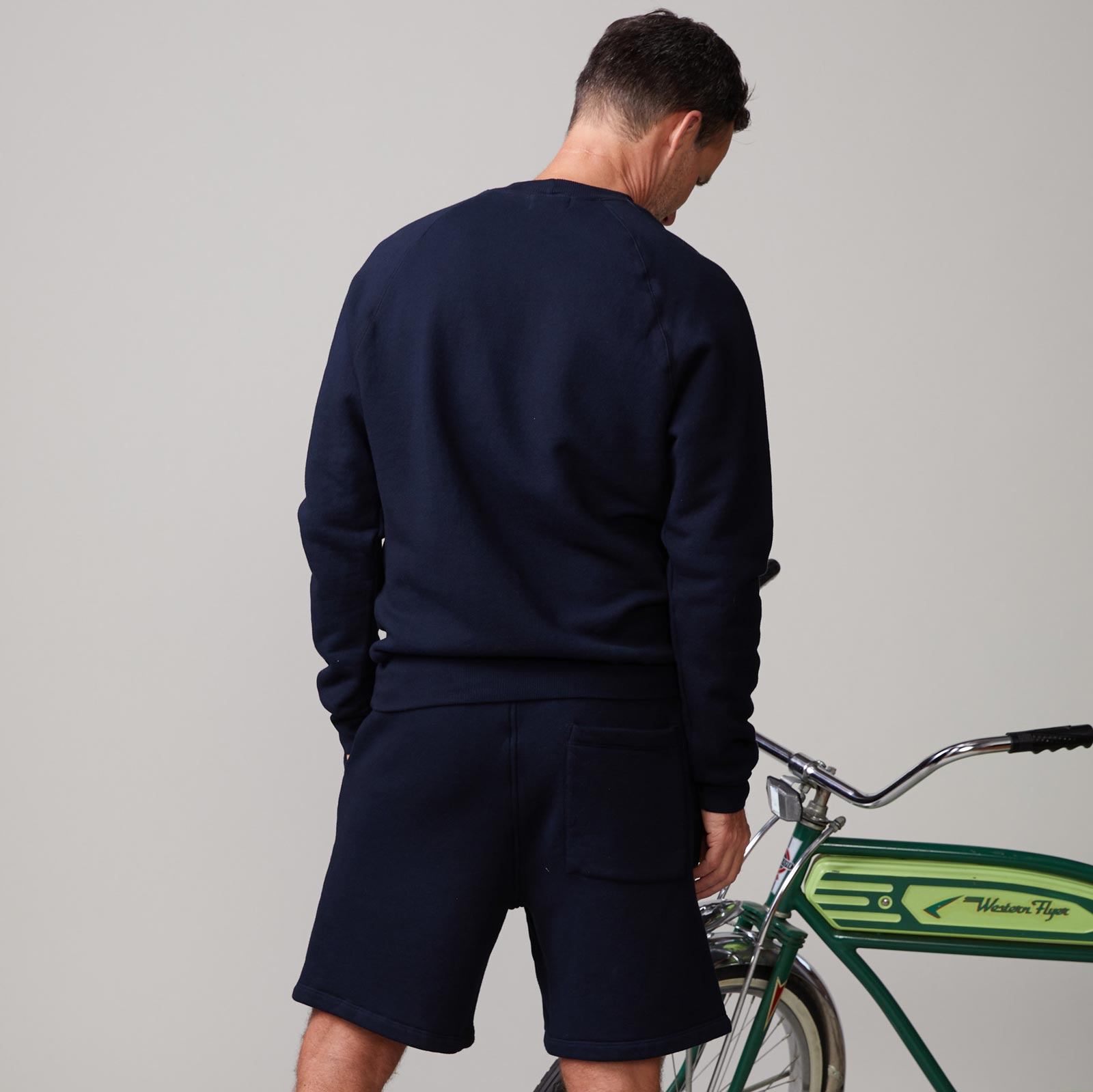 Back view of model wearing the 70's raglan in indigo.