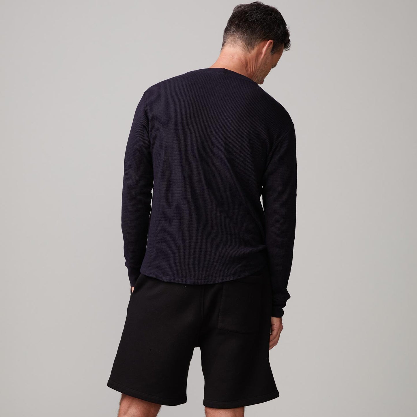 Back view of model wearing the thermal long sleeve crew in black.