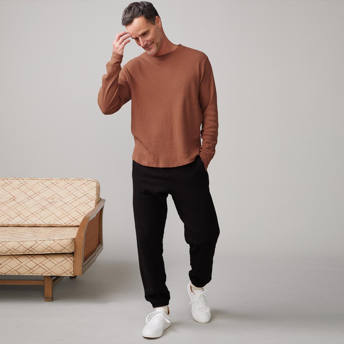 Front view of model wearing the thermal long sleeve crew in caramel.