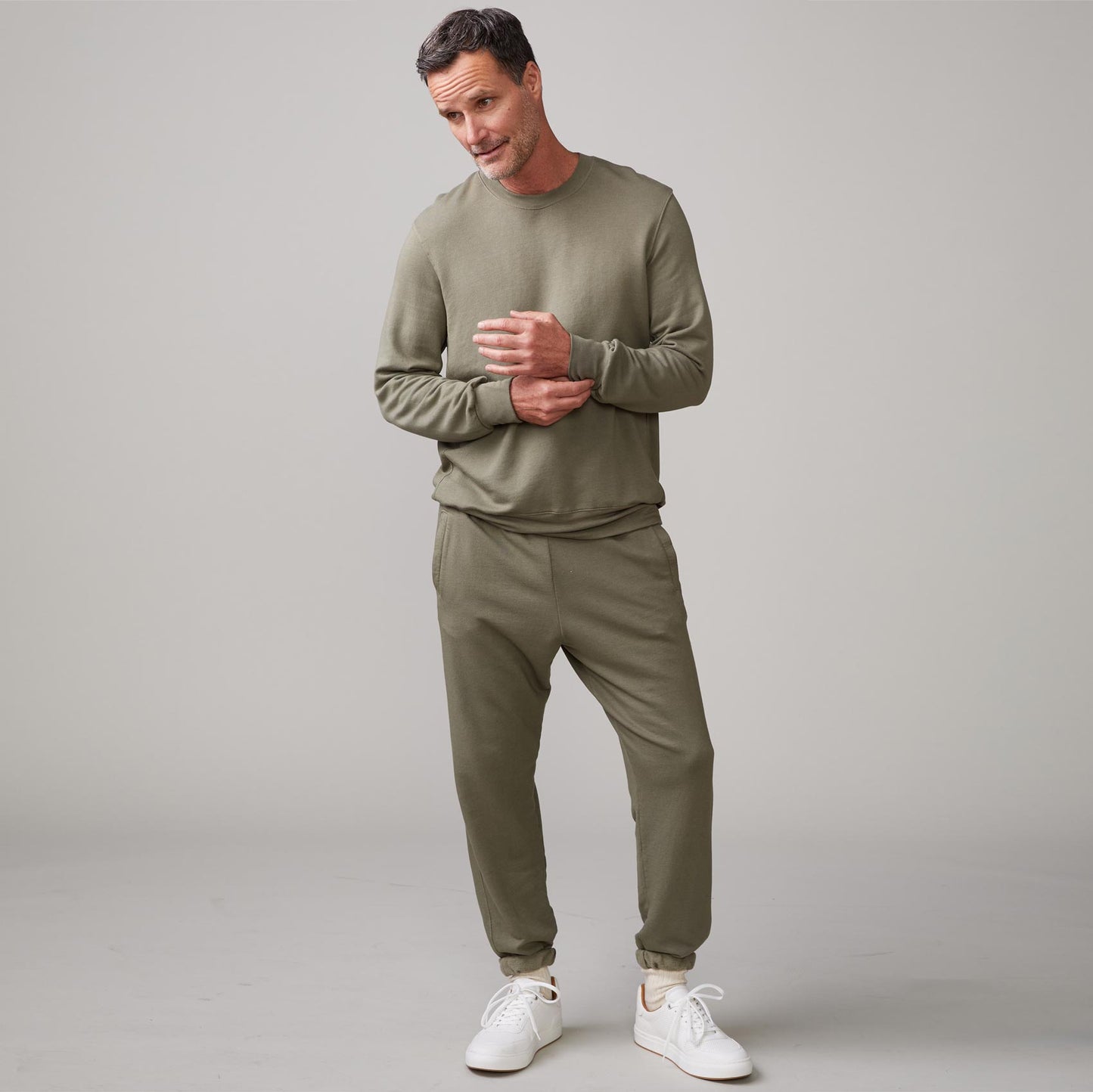 Front view of model wearing the lounge sweatshirt in army.