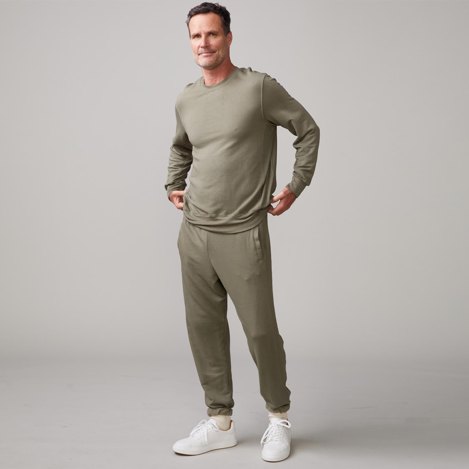 Front view of model wearing the lounge sweatshirt in army.