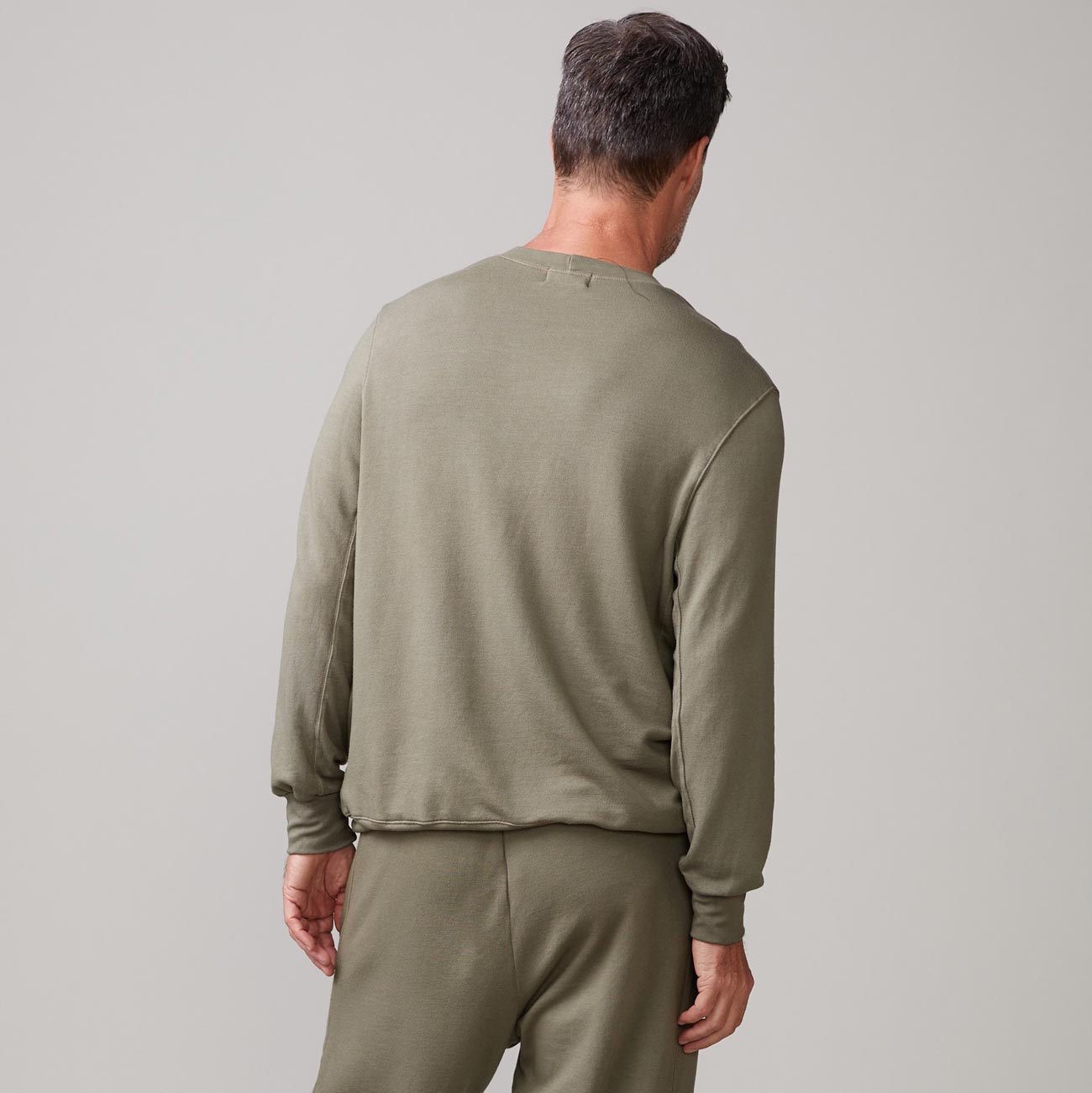 Back view of model wearing the lounge sweatshirt in army.