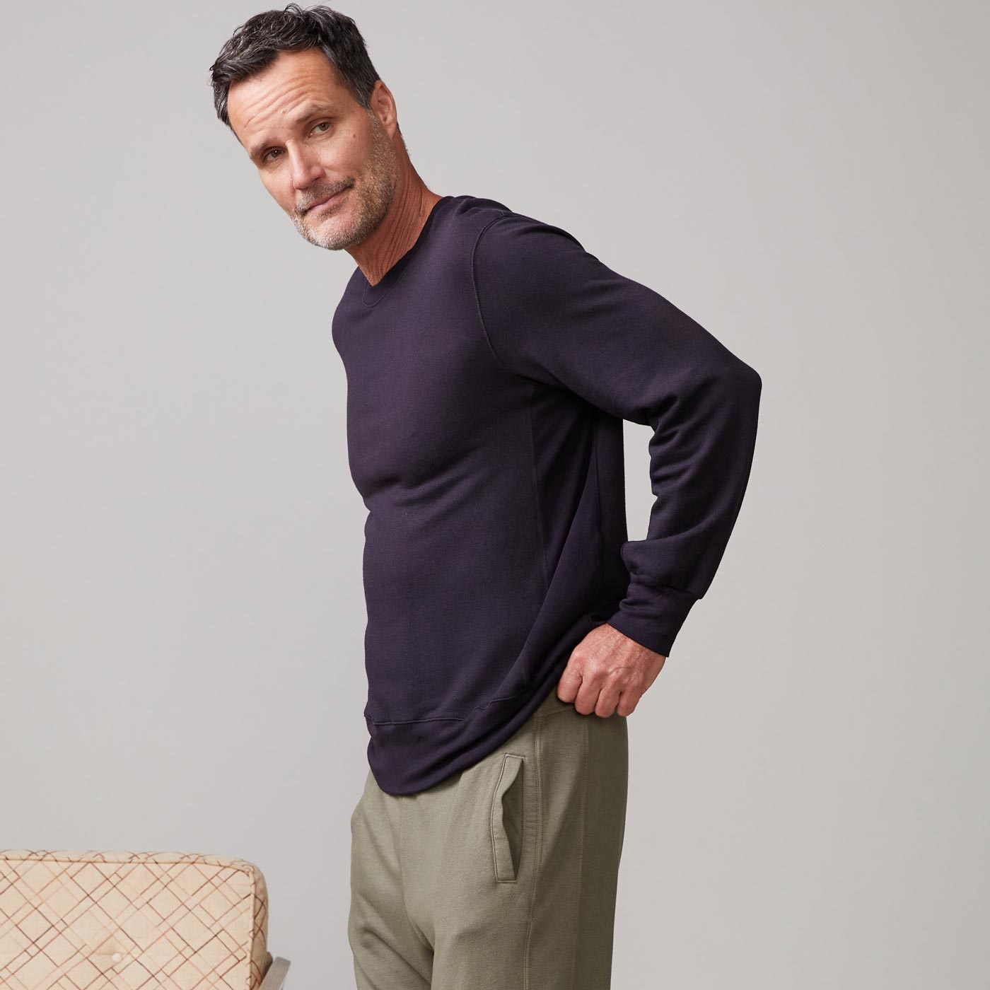 Side view of model wearing the lounge sweatshirt in faded black.