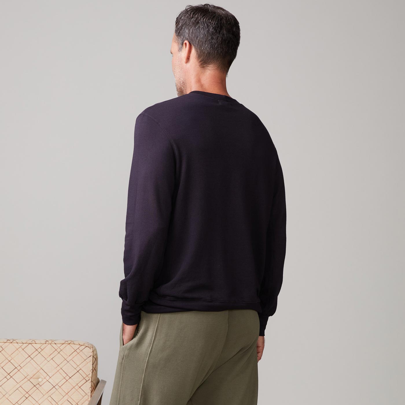 Back view of model wearing the lounge sweatshirt in faded black.