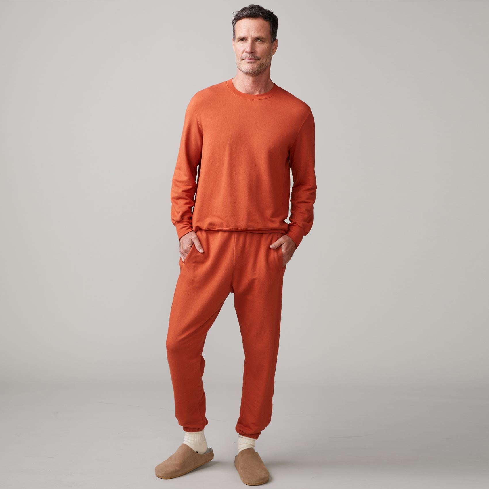 Front view of model wearing the lounge sweatshirt in faded rust.