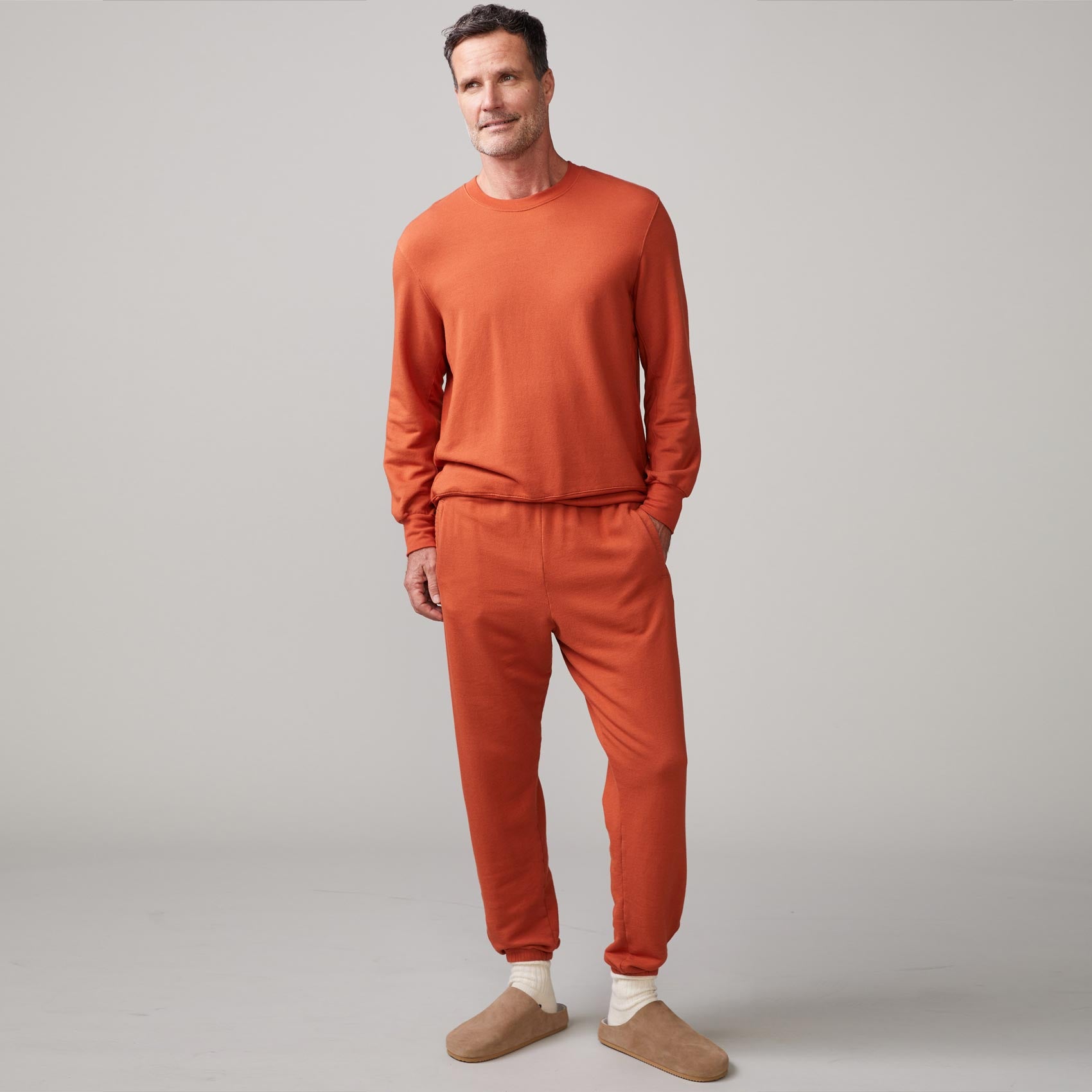 Front view of model wearing the lounge sweatshirt in faded rust.