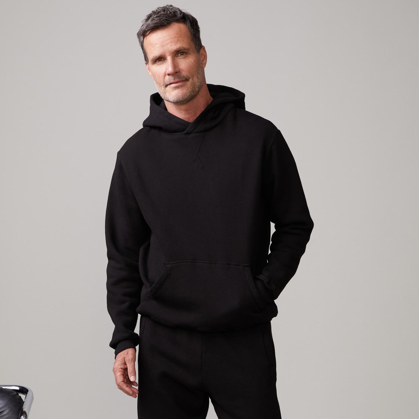Front view of model wearing the oversized hoody in black.