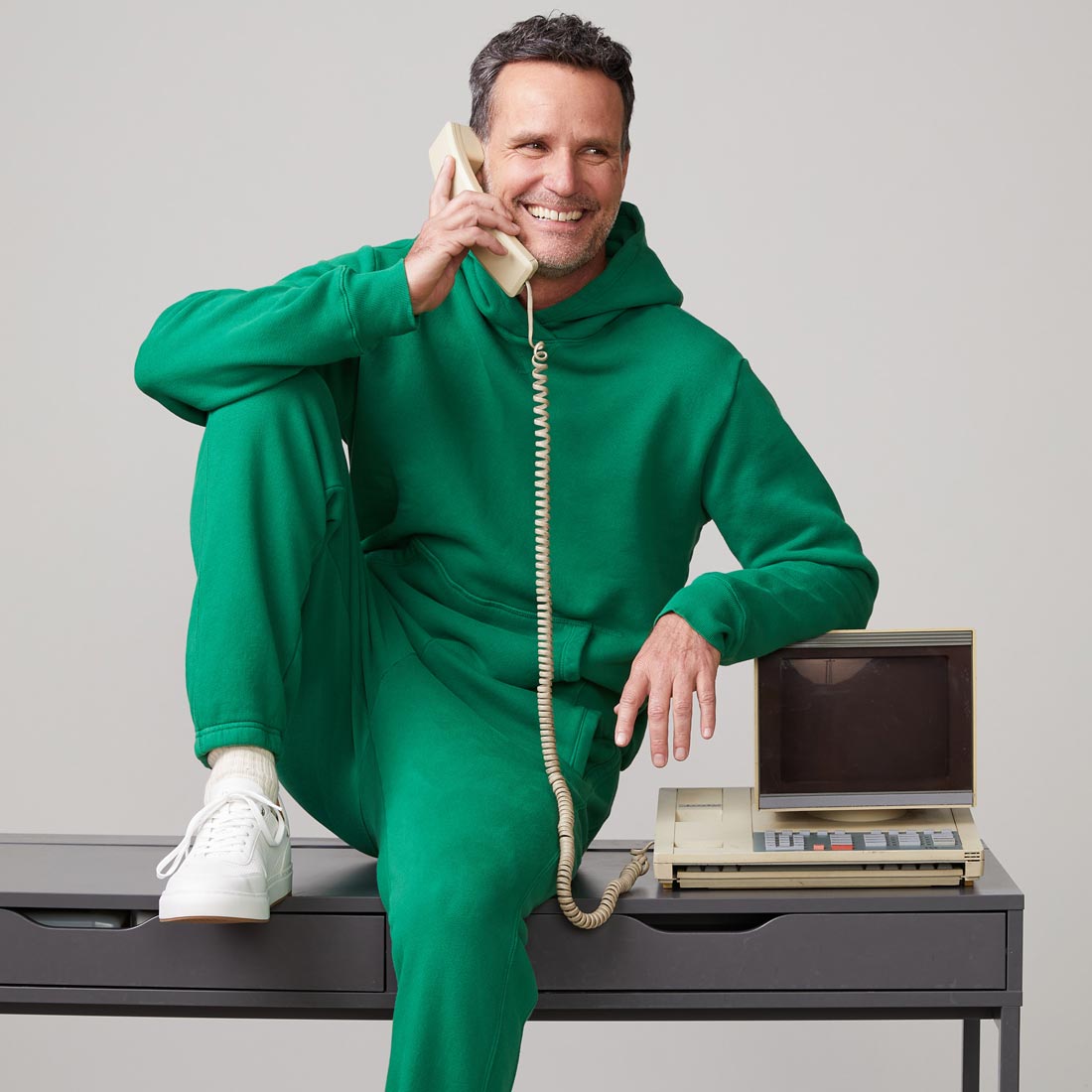 Front view of model wearing the oversized hoody in dusty kelly.