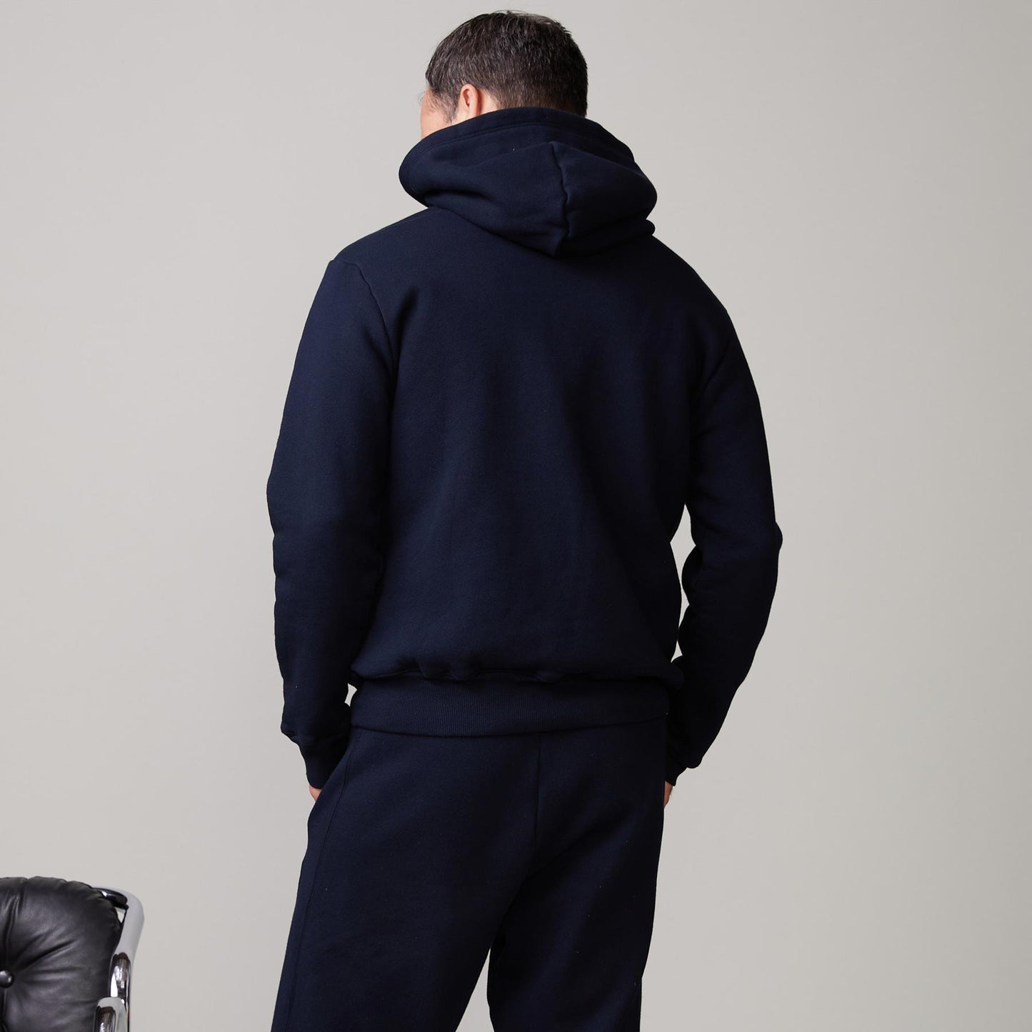 Back view of model wearing the oversized hoody in indigo.