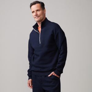 Front view of model wearing the half zip sweatshirt in indigo.