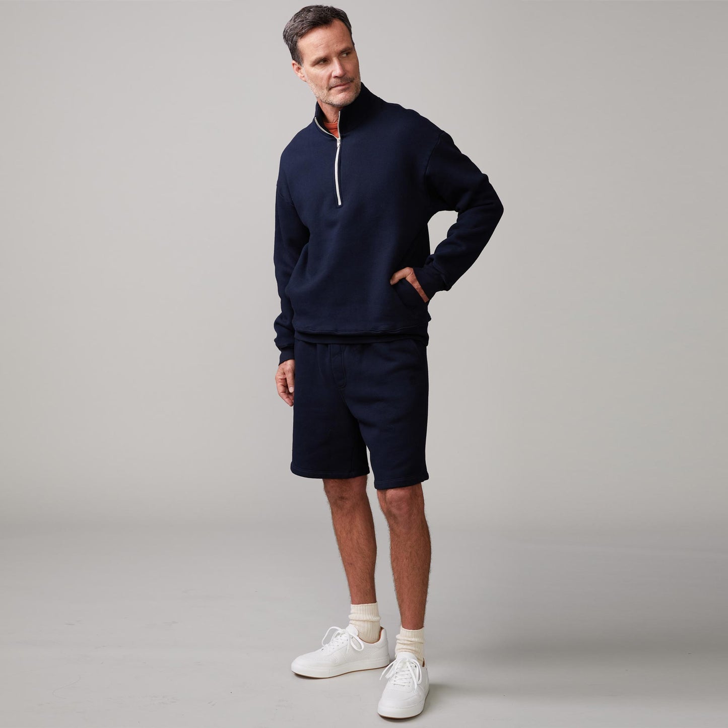 Front view of model wearing the half zip sweatshirt in indigo.