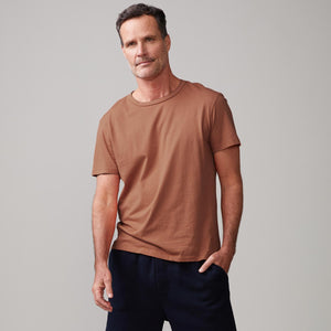 Front view of model wearing the relaxed crew in rust.