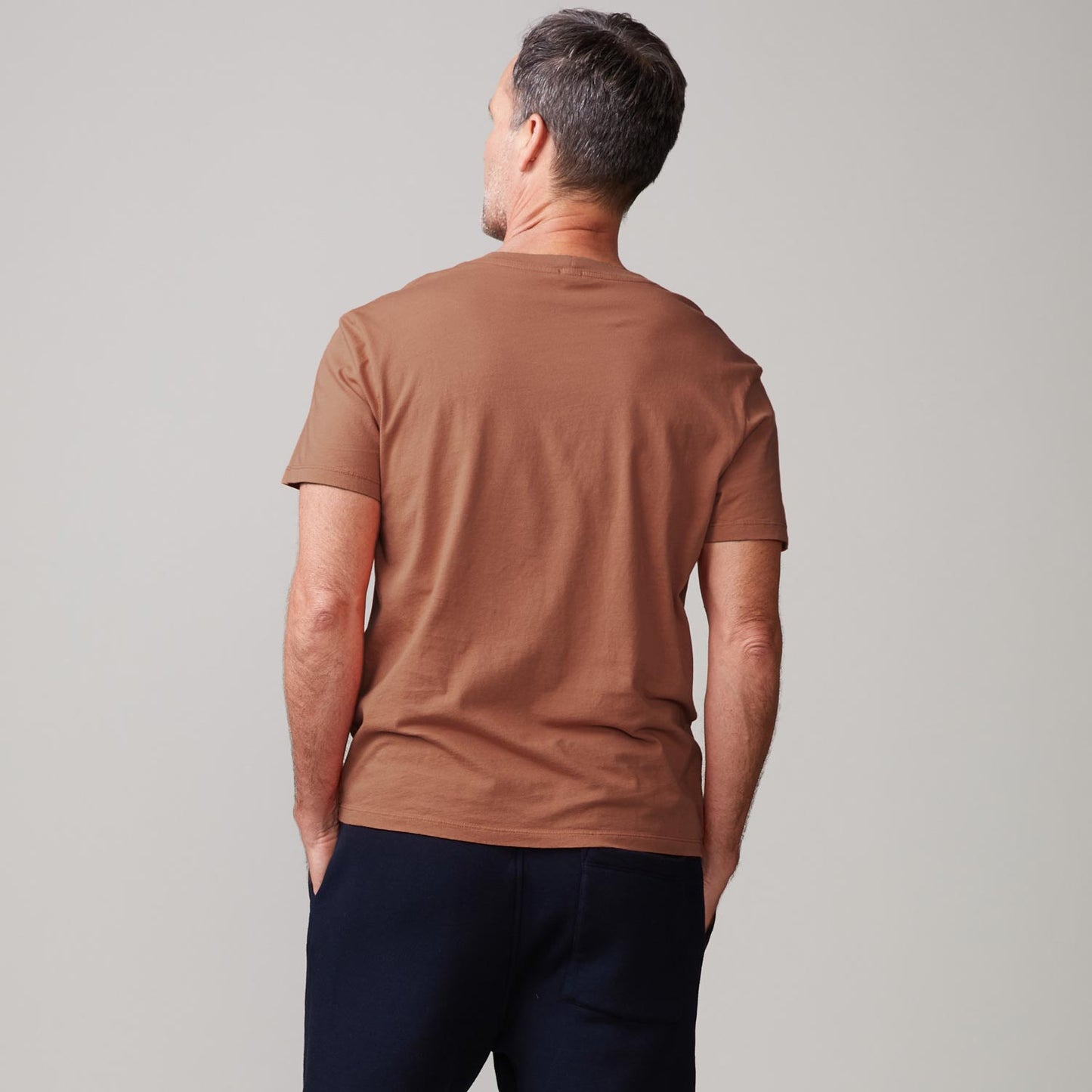 Back view of model wearing the relaxed crew in rust.