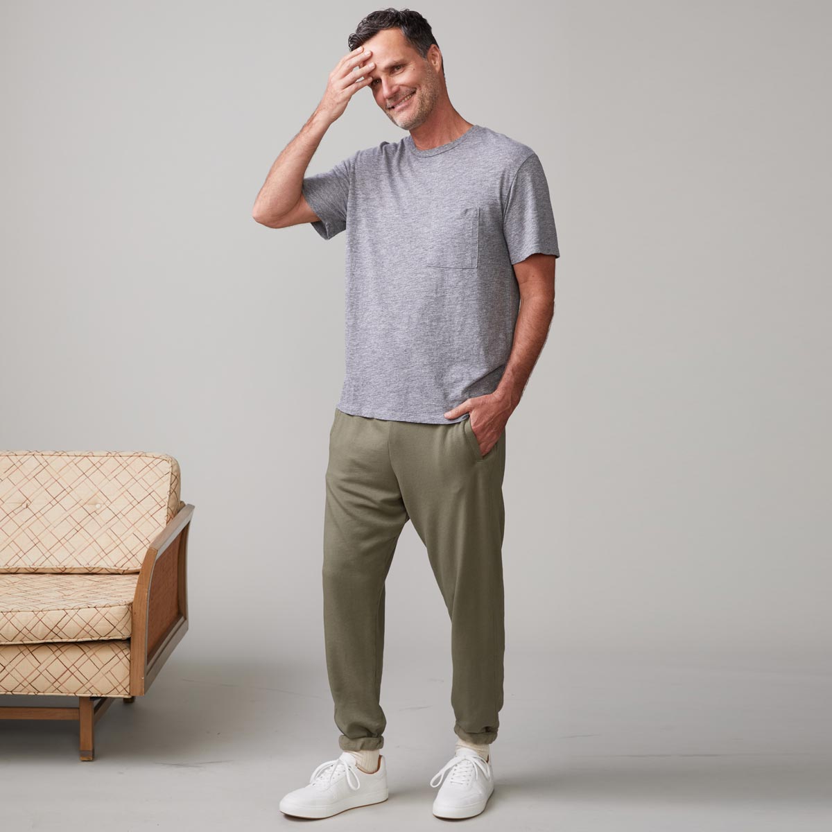 Front view of model wearing the textured tri-blend relaxed pocket crew in granite.