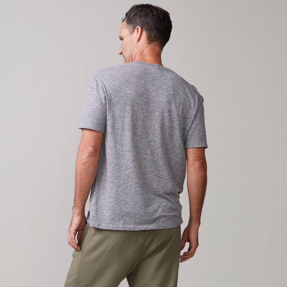 Back view of model wearing the textured tri-blend relaxed pocket crew in granite.