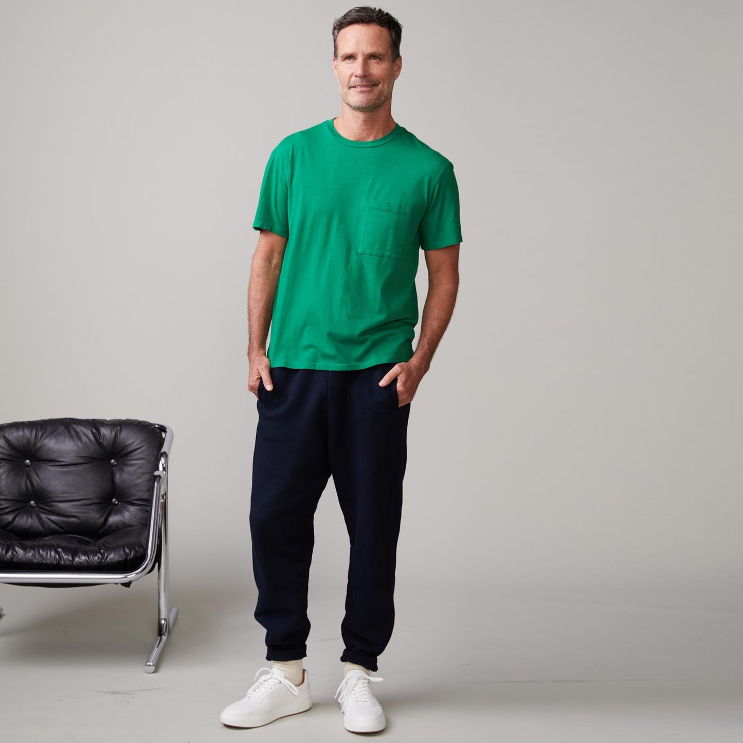 Front view of model wearing the relaxed pocket crew in dusty kelly.