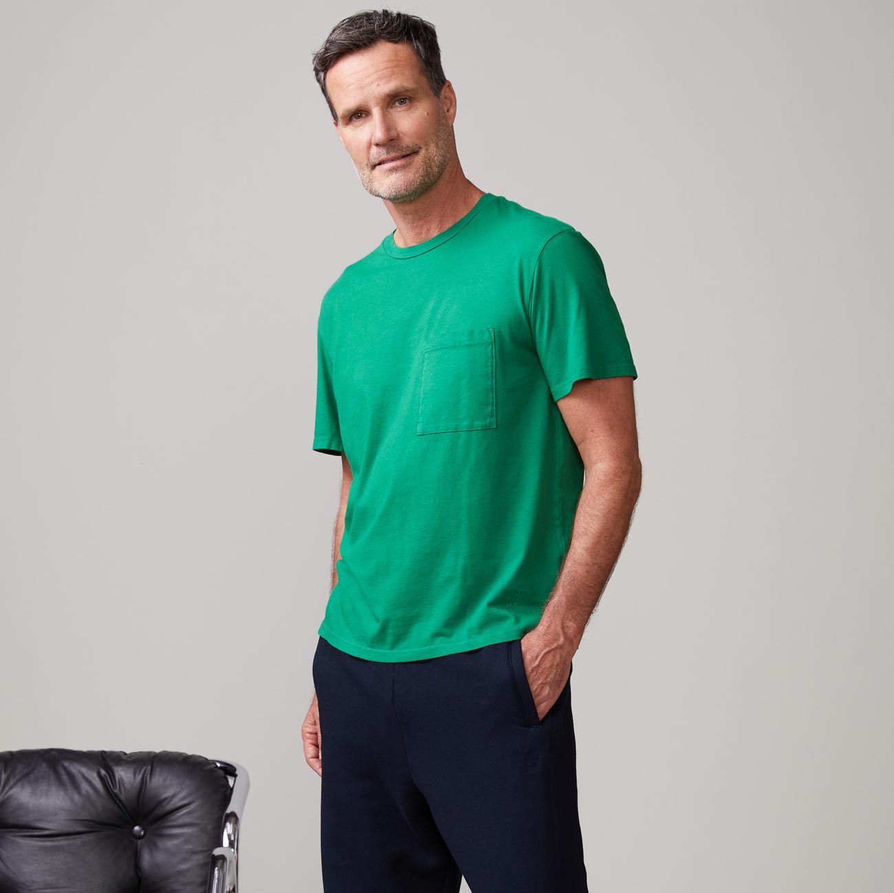 Front view of model wearing the relaxed pocket crew in dusty kelly.