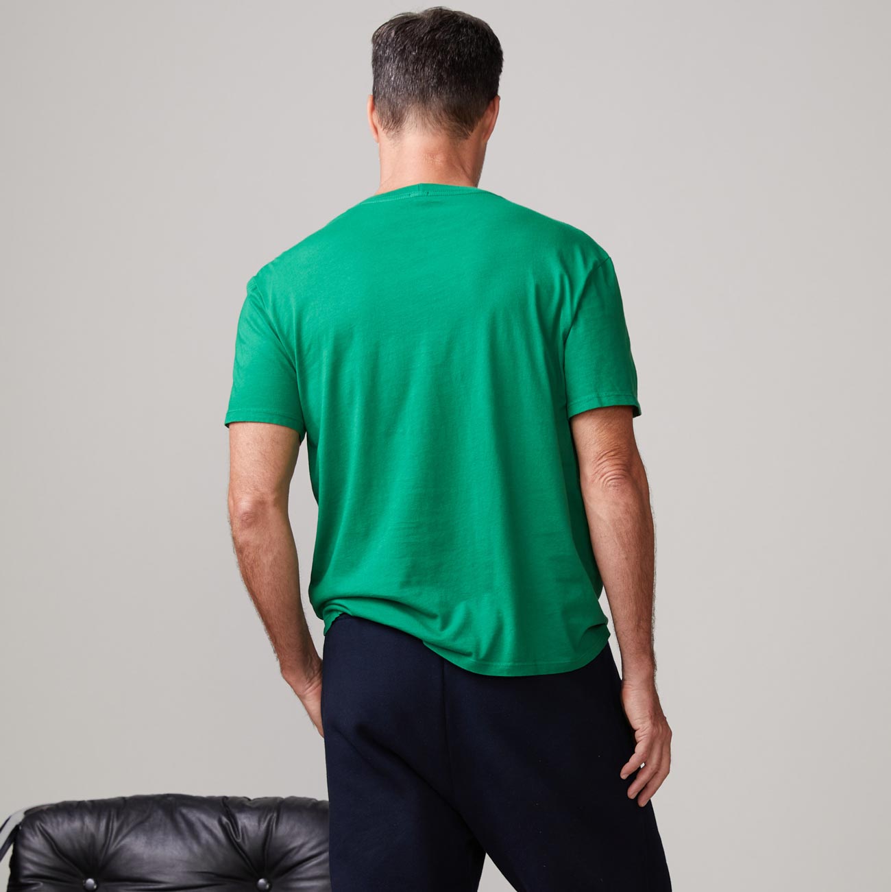 Back view of model wearing the relaxed pocket crew in dusty kelly.