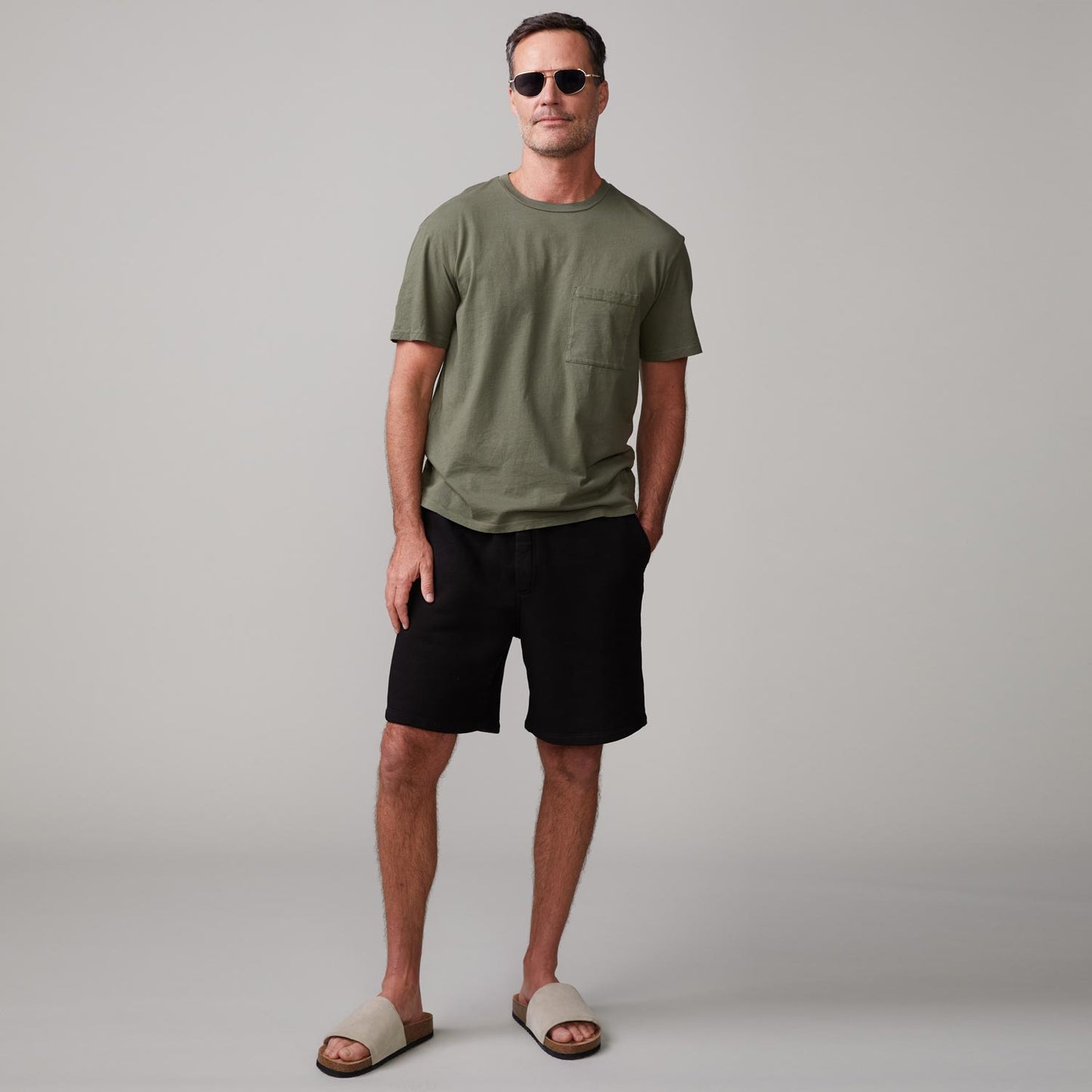 Front view of model wearing the relaxed pocket crew in general green.
