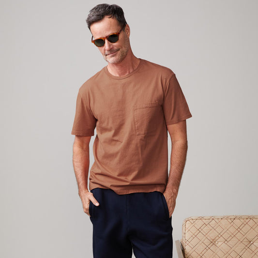 Front view of model wearing the relaxed pocket crew in rust.