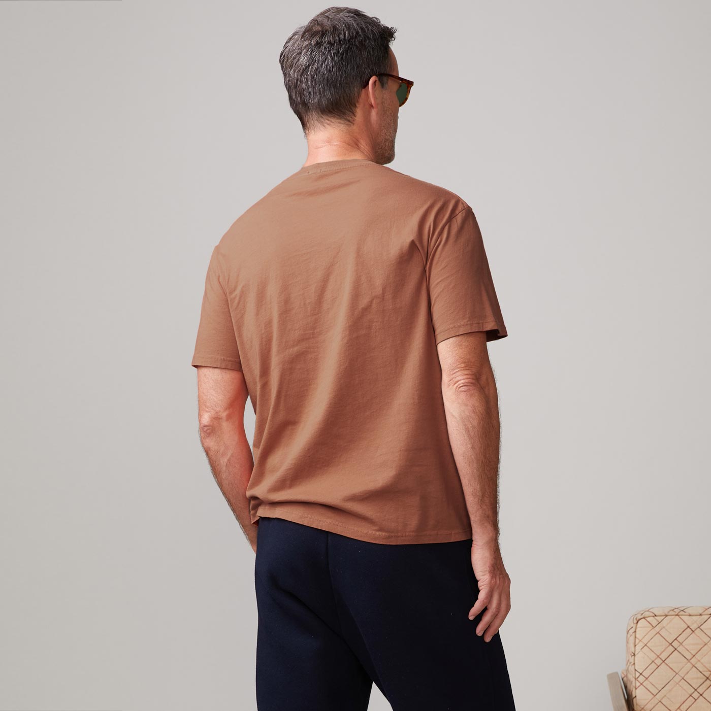 Back view of model wearing the relaxed pocket crew in rust.